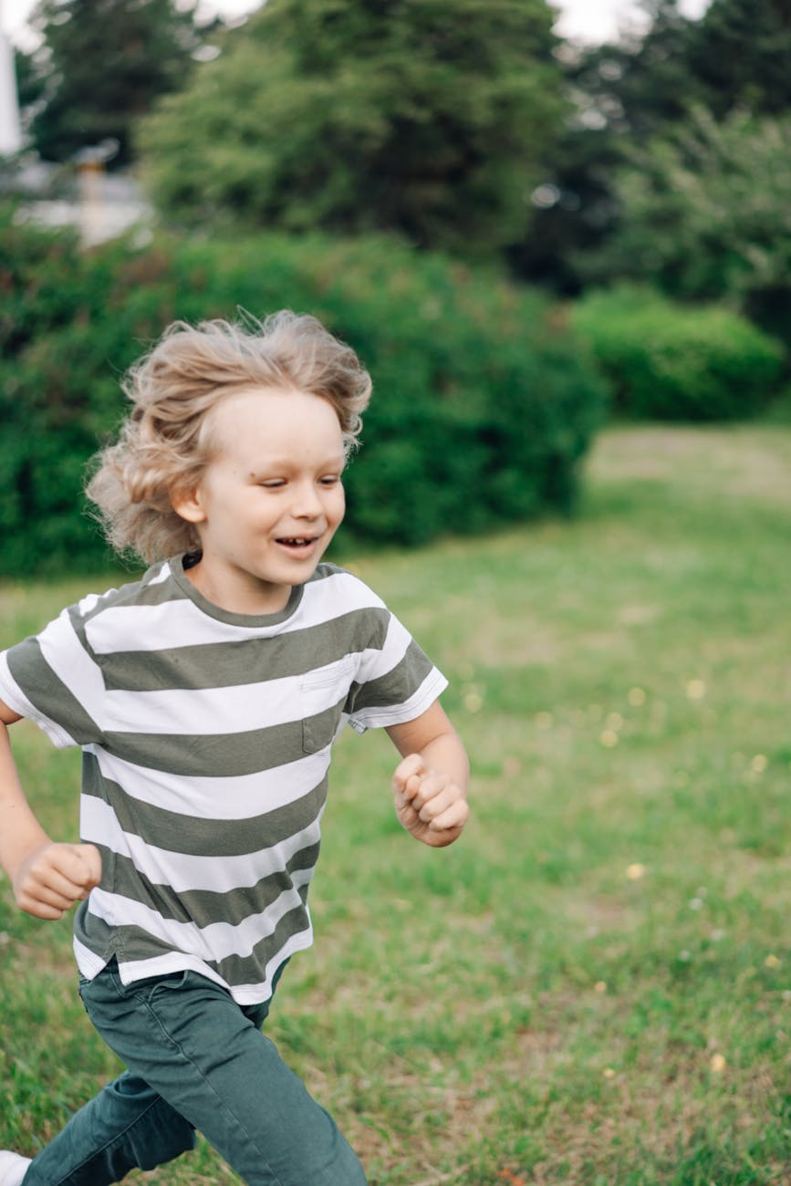 a boy in striped shirt running