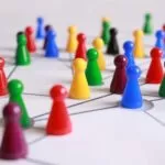 close up photography of yellow green red and brown plastic cones on white lined surface